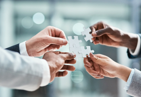 Hands with a puzzle piece