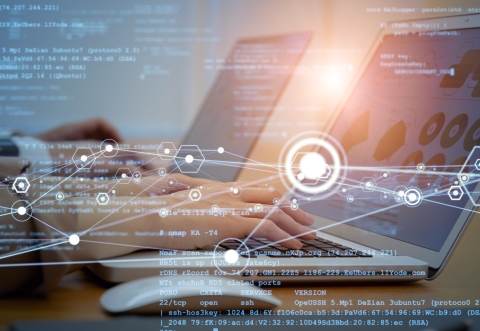 hands typing on laptop against a virtual background