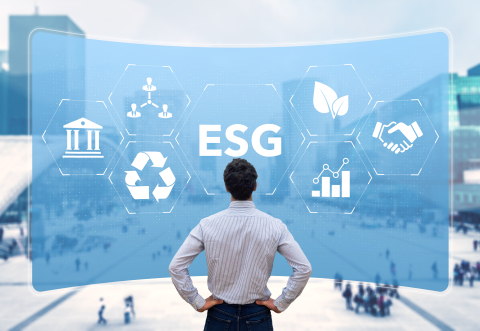 A man looking at a blue wall of ESG symbols
